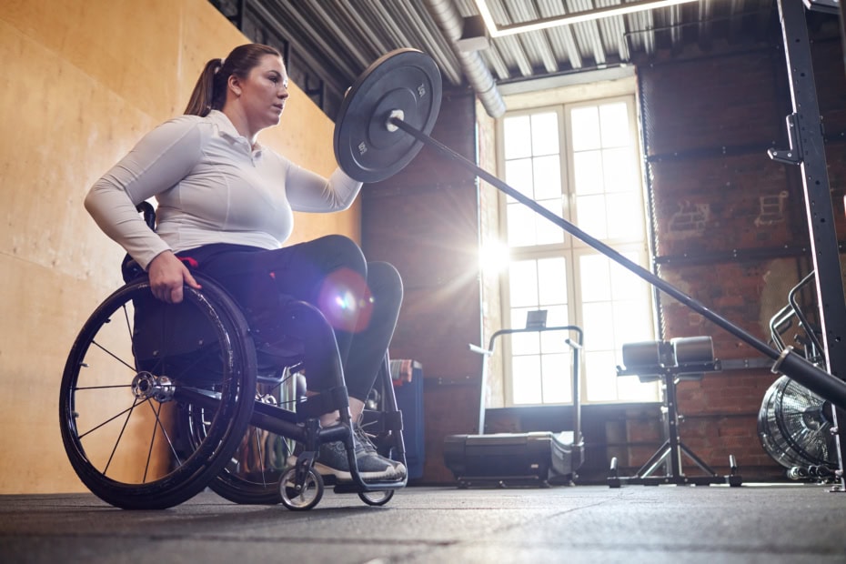 Woman With Disability useing a Barbell in Adapted Exercise