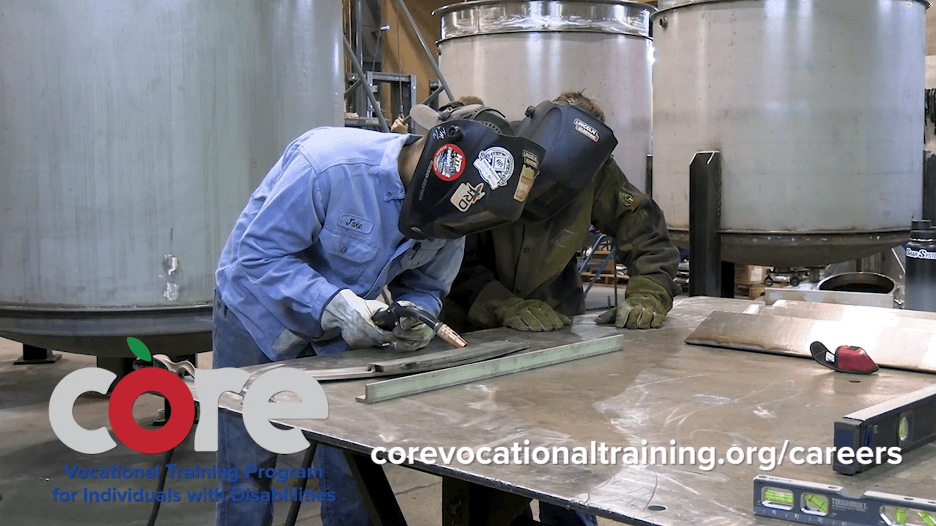 Welding instructor working with CORE participant